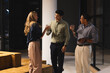 © Wavebreak Media - Diverse colleagues enjoying drinks and conversation at office during evening gathering