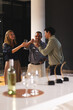 © Wavebreak Media - Diverse colleagues celebrating success with wine glasses in modern office setting