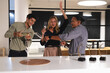 © Wavebreak Media - Celebrating success, diverse colleagues toasting with champagne in modern office