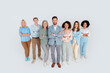 © deagreez - Group of diverse professionals standing together confidently against a grey background, showcasing teamwork, partnership, and leadership
