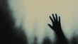 © Kepler - Mysterious shadow of raised hand reaching out against blurred background