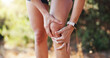 © peopleimages.com - Hands, athlete and woman with knee pain outdoor from fitness injury, sports emergency and arthritis. Active person, massage and joint tension from running mistake, exercise accident and muscle sprain