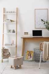 Poster - stylish ottoman with magazine on floor in modern home office. interior design