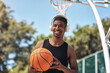 © peopleimages.com - Basketball, man and headphones with ball on court for match practice, workout music or fitness training. African person, sports player and listening to radio for game performance or exercise playlist