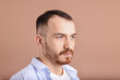 © New Africa - Baldness problem. Man with receding hairline on dark beige background, space for text