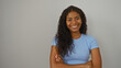 © Krakenimages.com - Young woman smiling with arms crossed against an isolated white background showcasing confidence and beauty