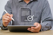 © Bordinthorn - Close-up of a person using a tablet and stylus, with digital documents and checkmark overlay, representing digital approval and modern business solutions.