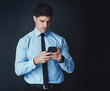 © peopleimages.com - Phone, ideas and businessman in studio with mockup space for finance investment planning. Cellphone, problem solving and male financial manager with stock market trading online by black background