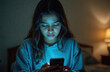 © miss irine - Girl using phone at night in bedroom. Teen checks social media at home. Adolescent illuminated by glow from smartphone screen. Online presence obsession, fear of negative evaluation issues, trouble,