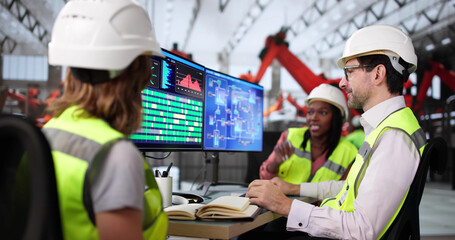 Poster - Technician uses computer to monitor production line