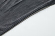 © Nugi - Close-up View of a Black Fabric Showing Texture and Stitching Details for Textile Evaluation