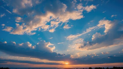 Aufkleber - Dramatic sunset with sun rays shining through clouds in a blue sky over a scenic landscape during twilight hours