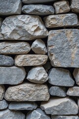 Poster - Textured stone wall with various shapes and sizes of gray and beige rocks arranged in a natural pattern