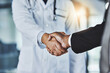 © Donson2000/peopleimages.com - People, handshake or doctor with business for partnership, medical funding or health campaign. Closeup, b2b or shaking hands with investor for financial agreement, clinic research or deal at hospital