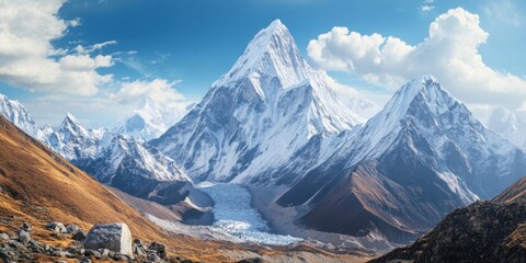 Aufkleber - Majestic snow-capped mountain peaks under a blue sky with wispy clouds, golden grass in the foreground, highlighting a stunning trekking landscape.