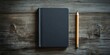 © Gular - Black notebook mockup with a wooden surface background, positioned left of a sharpened pencil, creating a minimalist and creative workspace aesthetic.