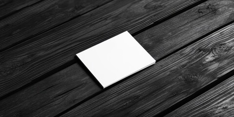 Poster - Minimalistic mockup of a blank business card on dark wooden planks with a black and white gradient tone creating a modern, elegant atmosphere.