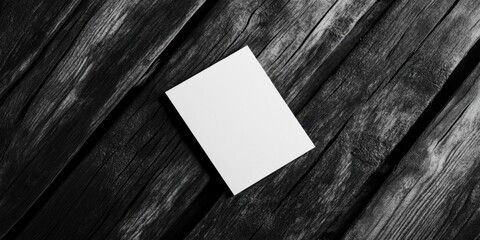 Poster - Business card mockup on dark wooden background with textured black and white gradient showcasing blank template in tilted position.