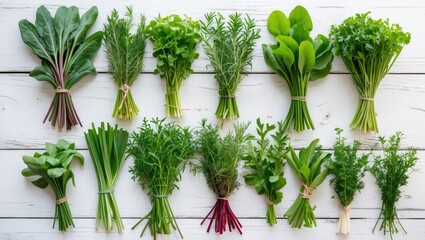 Wall Mural - Assorted fresh green herbs and leafy greens arranged on a white wooden surface perfect for spring salad preparation and healthy eating.