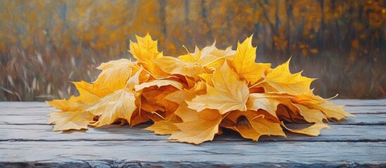 Aufkleber - Vibrant yellow maple leaves arranged in a pile on a weathered wooden table with a blurred autumnal background showcasing seasonal beauty.