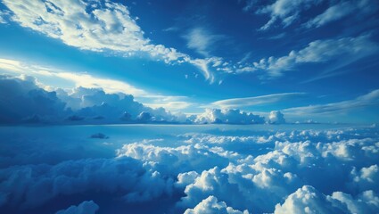 Wall Mural - aerial view of a vast sky filled with fluffy white clouds against a deep blue background capturing s