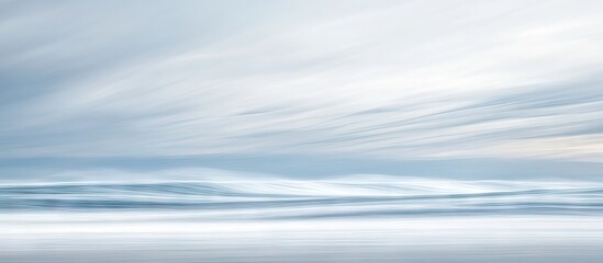 Poster - Calm abstract ocean seascape featuring soft blue and white hues, with gentle waves blending into a smooth, tranquil horizon under a serene sky.