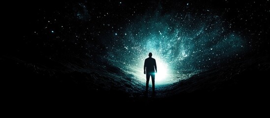 Aufkleber - Silhouette of a person standing against a vibrant swirling galaxy in shades of blue and teal, with a deep black background emphasizing the scene.