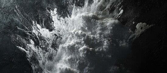 Aufkleber - White powder splashing against a dark textured background creating a striking contrast with dynamic movement and soft white wisps on black surface.
