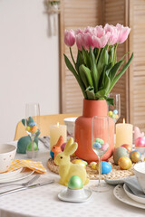 Wall Mural - Festive table setting with vase of tulips, candles, painted eggs and Easter