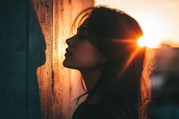 Aufkleber - Woman enjoying sunset light while leaning against a wall in a serene outdoor setting during golden hour. Generative AI