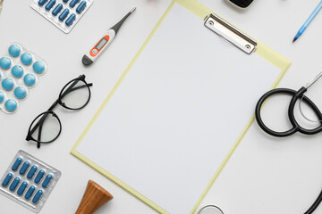 Wall Mural - Blank clipboard with medical supplies on white background. World Health Day