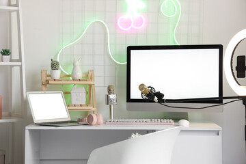 Wall Mural - Blogger's workplace with blank computer monitor and laptop in office