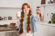 © Pixel-Shot - Teenage redhead girl with nut butter and milk in kitchen