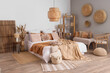 © Pixel-Shot - Interior of cozy bedroom with big bed, shelf unit and bench