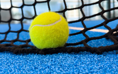 Wall Mural -  paddle tennis balls near the lines of a blue paddle tennis court, racket sports concept