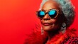 © Nataliia_Trushchenko - Woman in a red outfit with a leopard print scarf and sunglasses. She is wearing red lipstick and has her hair in a bun