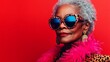 © Nataliia_Trushchenko - Woman in a red background wearing a pink and black outfit with a leopard print scarf and sunglasses