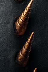 Canvas Print - Close-up of golden spikes on a dark surface. Textured and luxurious.