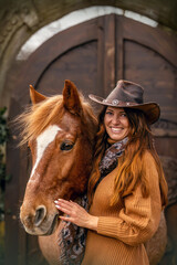 Wall Mural - A beautiful adult woman and her brown horse cuddle and interact together, equestrian team scene