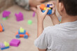 © thebaikers - Children playing with colorful plastick brick or toy block building a thing. Motoric activity. Child development image concept.