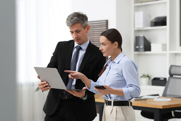 Wall Mural - Coworkers with laptop working together in office