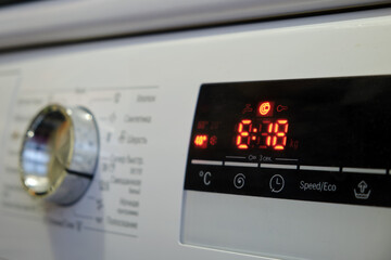 close-up of a washing machine control panel with a digital display and a error code e18. the red led