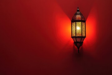 Wall Mural - An illuminated lantern hanging on a textured reddish wall