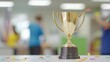 © amorn_m - Gold Trophy on Table with Confetti and Blurred Background People Celebrating Success