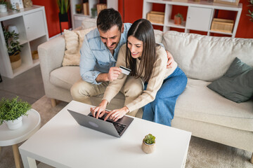 man and woman use credit card and laptop for online shopping at home