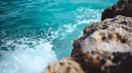 Leinwandbilder - Closeup perspective of ocean waves crashing against rocky shore with vibrant blue water : Generative AI
