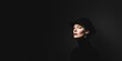 © Parkpoom - A striking portrait of a woman in a black hat against a dark background, showcasing dramatic lighting and a confident expression.