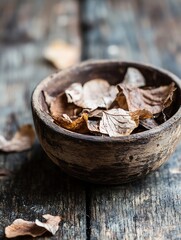 Poster - Natural rustic decoration featuring dry leaves in a wooden bowl placed on a textured wooden surface : Generative AI