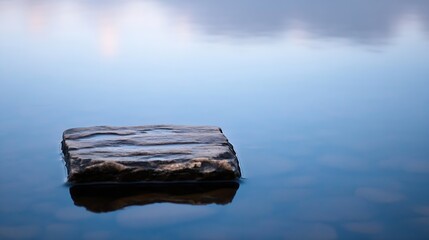 Fototapete - Solitary Stone in a Calm Reflective Water Surface During a Quiet Moment : Generative AI
