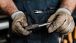 © MAKASIHMAS SIDNEY - Mechanic's hands holding tool, garage background, car repair
